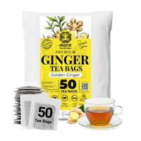 A package of Akshit Premium Ginger Tea Bags, featuring a white and yellow bag with illustrations of ginger root, alongside a stack of individual tea bags, loose ginger slices, and a glass cup of brewed ginger tea on a white background.