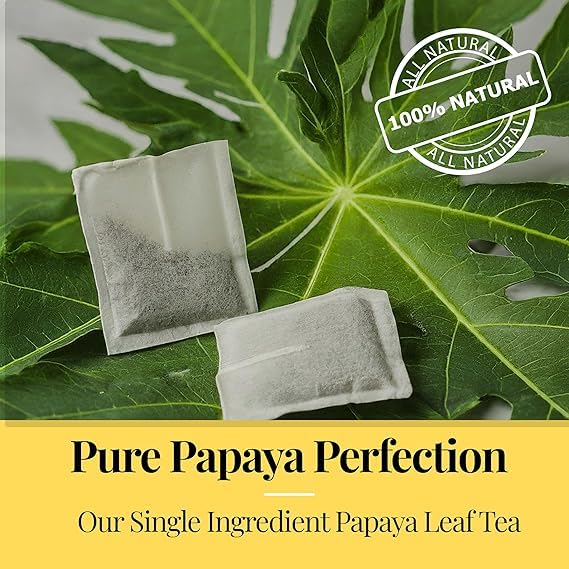 Papaya leaf tea bags on fresh leaf showing 100 percent natural single ingredient herbal tea for wellness and digestion support